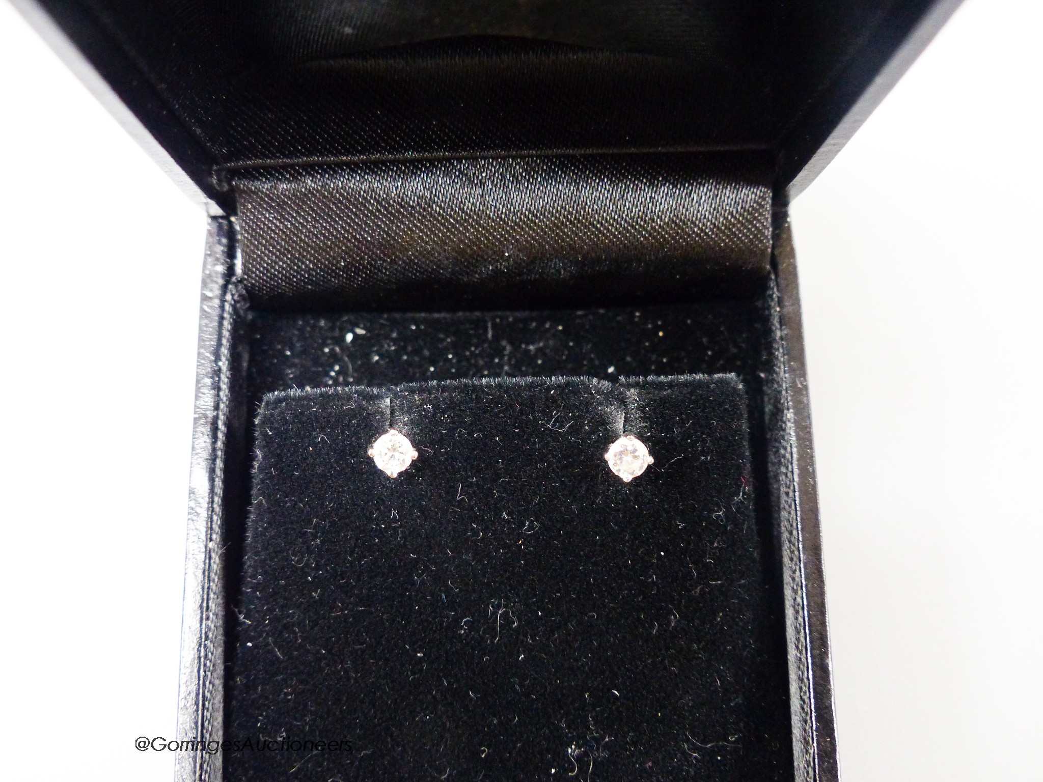 A modern pair of 18ct white gold and solitaire diamond set ear studs, gross weight 1.1 grams, each stone weighing approx.0.12ct.